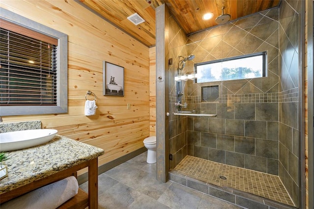 bathroom featuring an enclosed shower, vanity, wooden ceiling, toilet, and wood walls