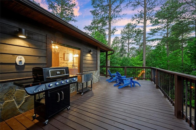 deck at dusk featuring area for grilling