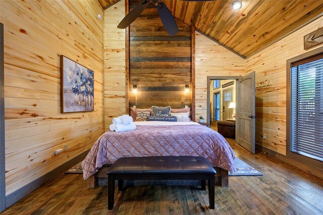 bedroom with high vaulted ceiling, wood ceiling, wooden walls, and wood finished floors