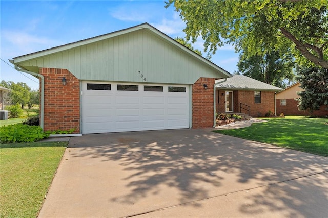 view of front of property featuring central AC, a garage, and a front lawn