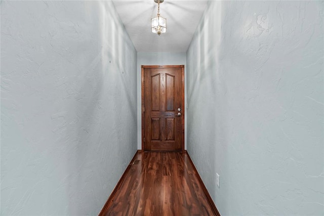 corridor featuring dark hardwood / wood-style floors