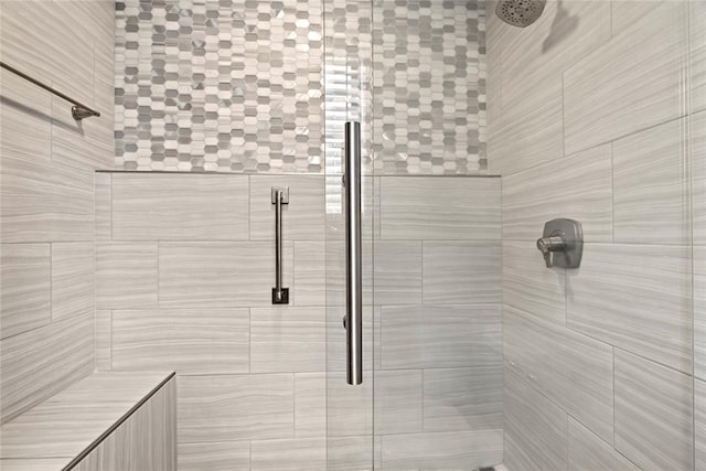 bathroom featuring a shower with door