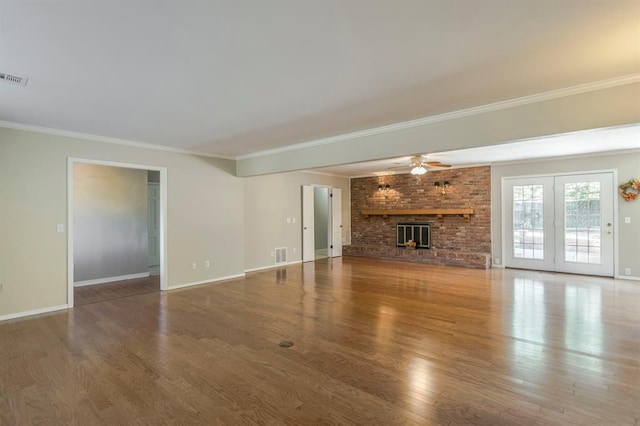 unfurnished living room with crown molding, a fireplace, ceiling fan, and wood-type flooring