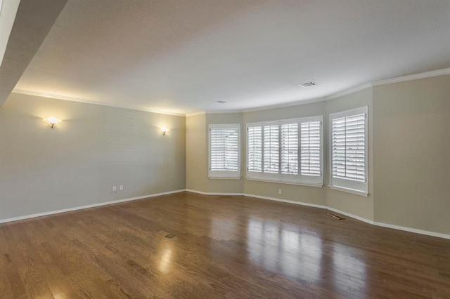 unfurnished room featuring crown molding and dark wood-type flooring