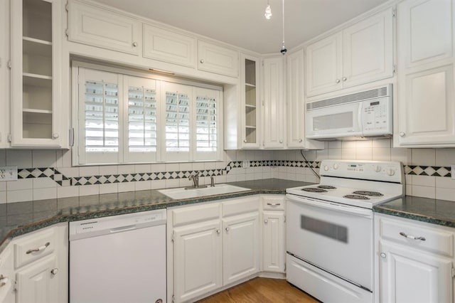 kitchen featuring white cabinets, white appliances, backsplash, and sink