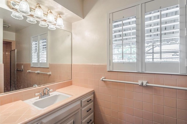 bathroom with vanity and tile walls