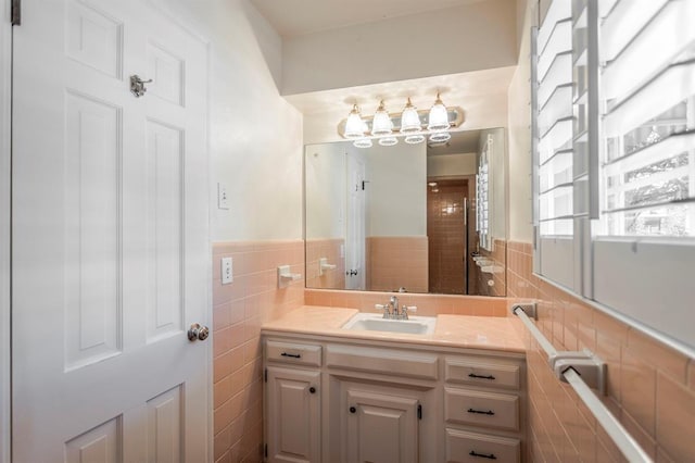 bathroom featuring vanity and tile walls