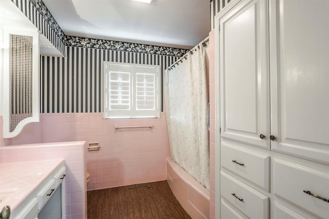 full bathroom featuring toilet, shower / bath combo with shower curtain, vanity, tile walls, and hardwood / wood-style flooring