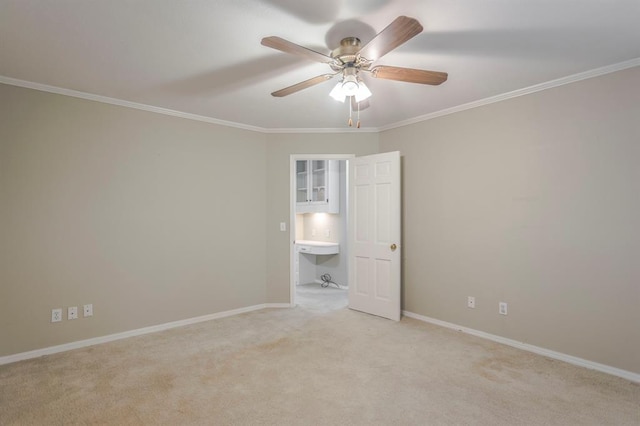 unfurnished room featuring ceiling fan, light colored carpet, and ornamental molding