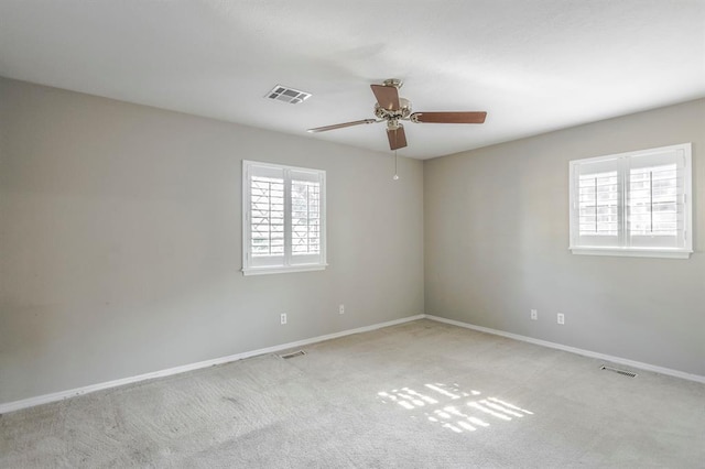 carpeted spare room with ceiling fan