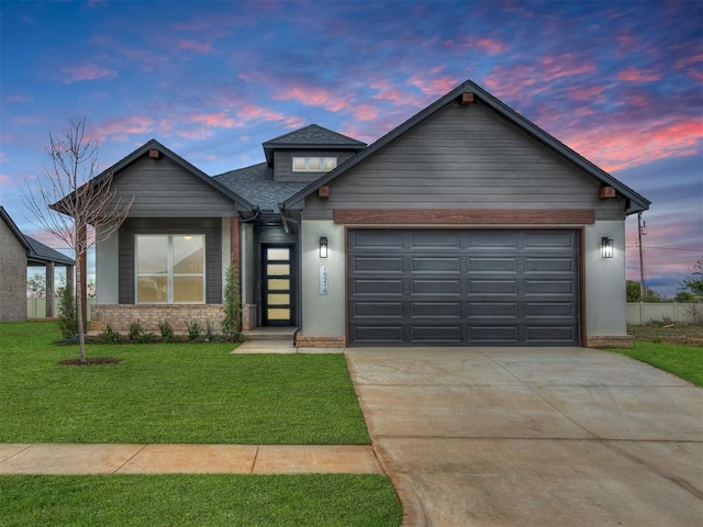 craftsman inspired home with a garage and a yard