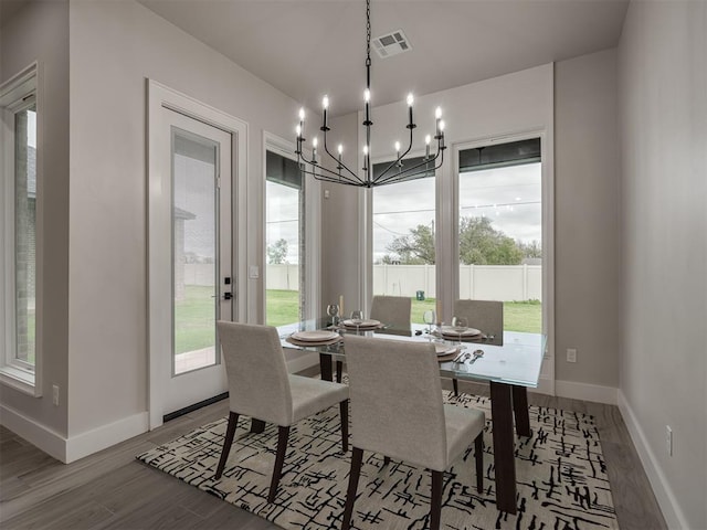 dining room featuring an inviting chandelier and light hardwood / wood-style flooring