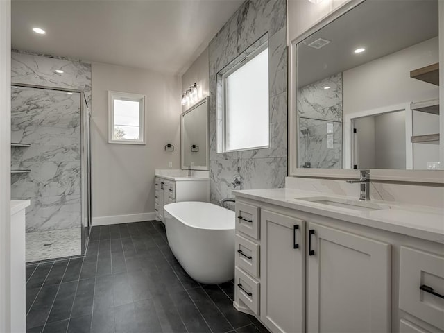 bathroom with vanity, separate shower and tub, and tile walls