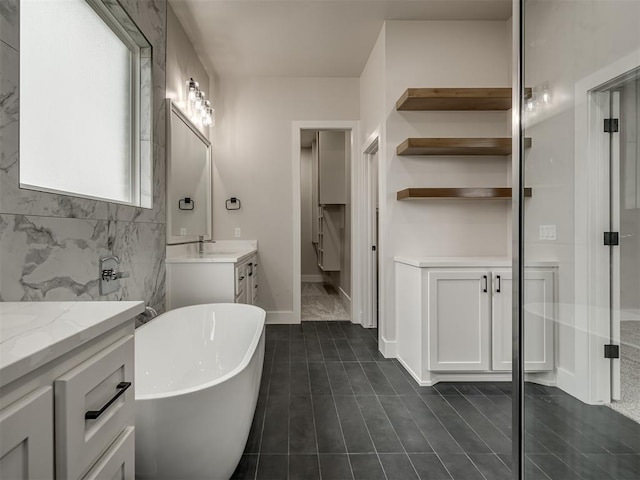 bathroom featuring independent shower and bath, vanity, and tile patterned floors