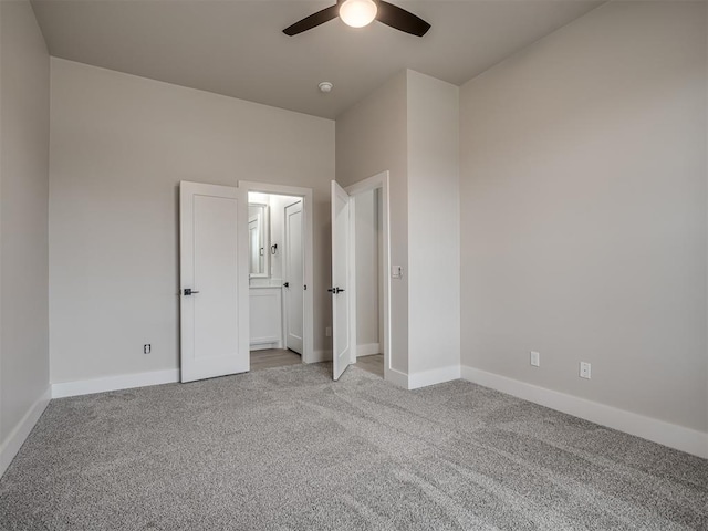 unfurnished bedroom featuring light carpet and ceiling fan