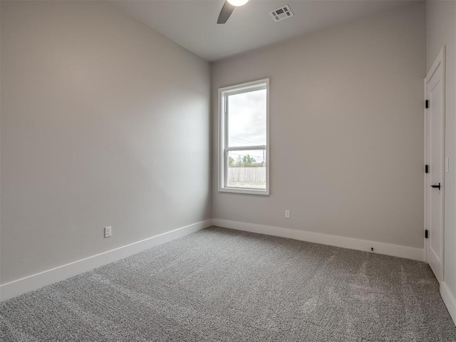 spare room with ceiling fan and carpet