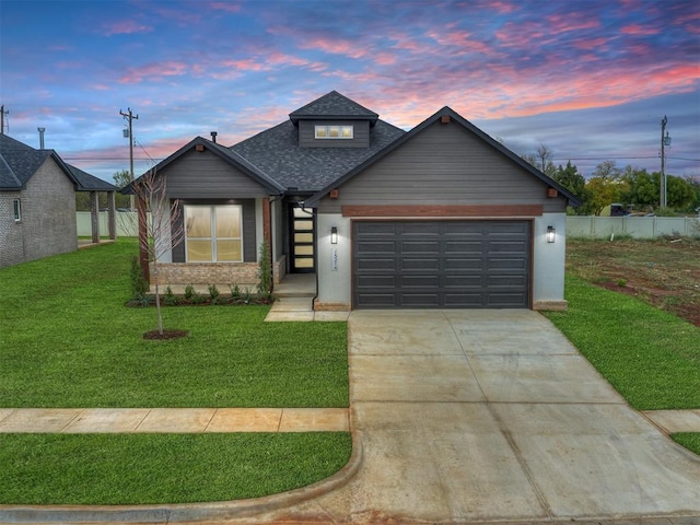 view of front facade with a garage and a lawn