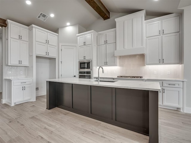 kitchen featuring white cabinetry, stainless steel appliances, and sink