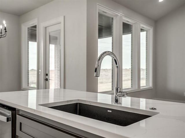 room details with light stone countertops and sink