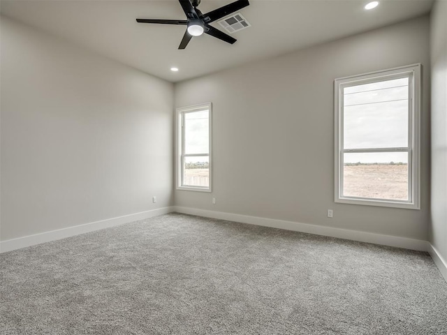 carpeted empty room featuring ceiling fan