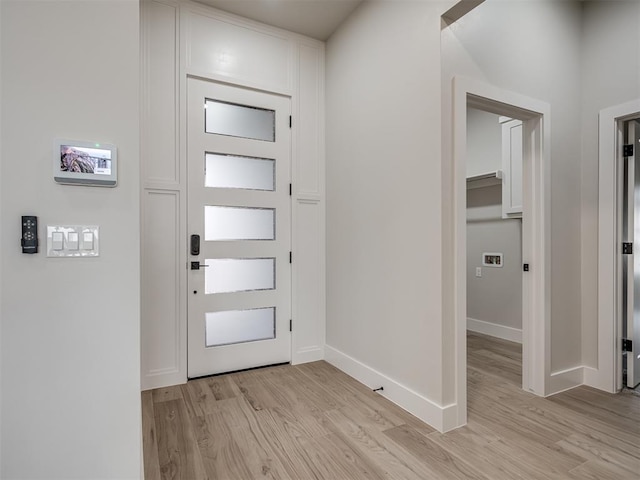 foyer entrance with light wood-type flooring