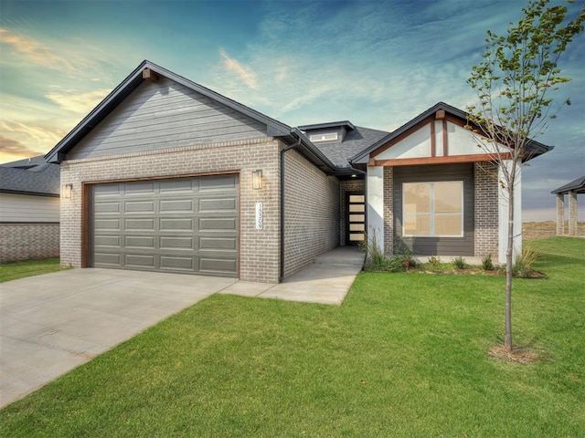 view of front of home with a garage and a lawn