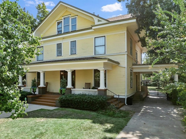 view of front of home with covered porch and a front lawn