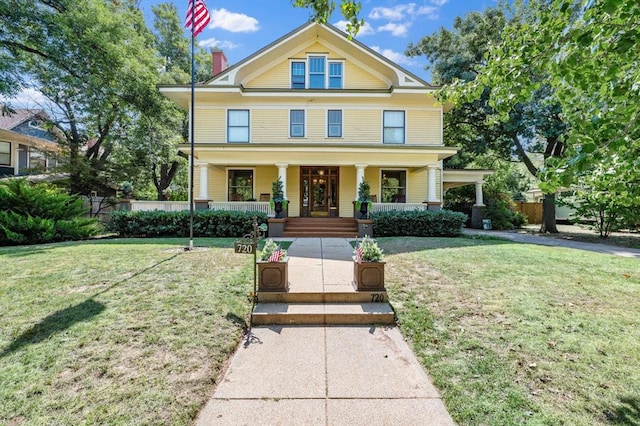 greek revival house featuring a porch and a front lawn