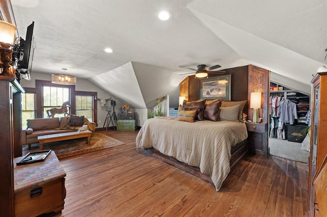 bedroom featuring ceiling fan, dark hardwood / wood-style flooring, and vaulted ceiling