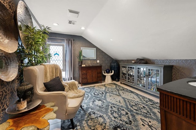 sitting room with vaulted ceiling