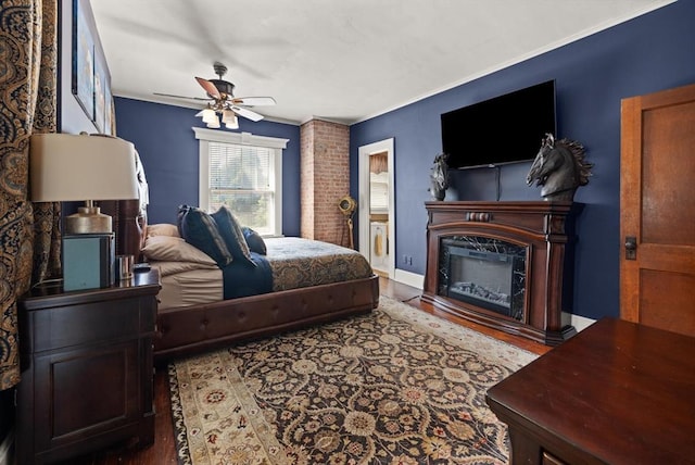 bedroom with ceiling fan, crown molding, and dark wood-type flooring