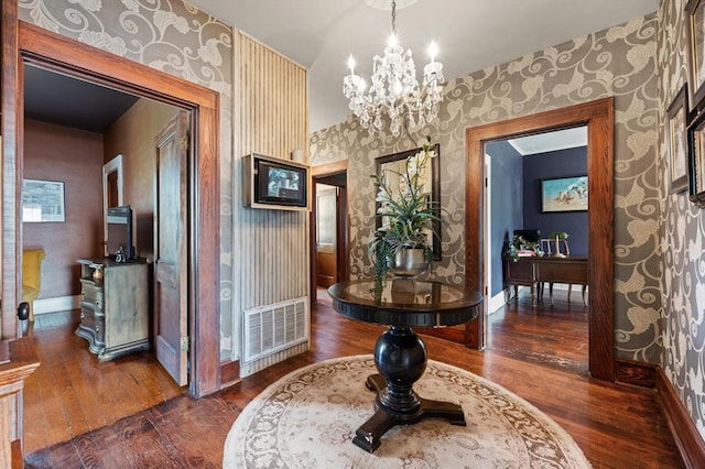 corridor with a notable chandelier and dark hardwood / wood-style flooring