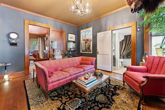 living room featuring dark hardwood / wood-style flooring, ornamental molding, and an inviting chandelier