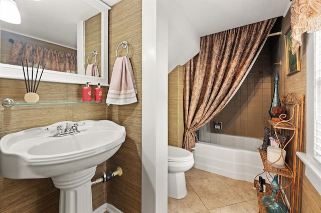 bathroom with toilet, tile patterned floors, and a bathtub