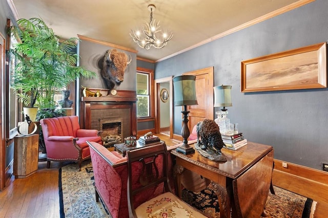 interior space featuring a chandelier, hardwood / wood-style flooring, a brick fireplace, and ornamental molding