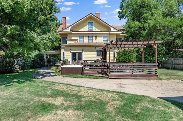 back of house featuring a pergola, a yard, and a wooden deck