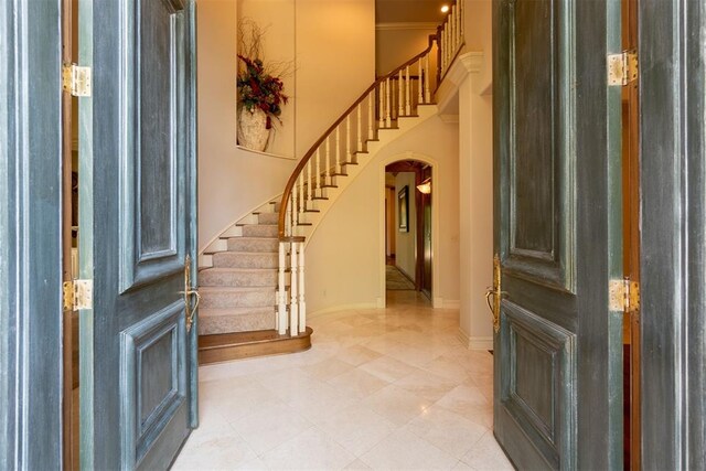 12308 Bywater Rd, Oklahoma City, OK 73170 - entryway featuring arched walkways, stairs, and light tile patterned floors