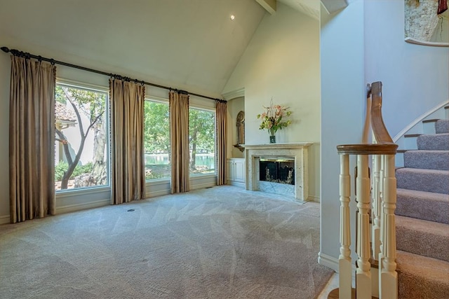 12308 Bywater Rd, Oklahoma City, OK 73170 - unfurnished living room with high vaulted ceiling, carpet floors, beam ceiling, stairway, and a premium fireplace