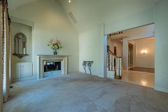 12308 Bywater Rd, Oklahoma City, OK 73170 - unfurnished living room with carpet floors, high vaulted ceiling, stairs, a fireplace, and ornate columns
