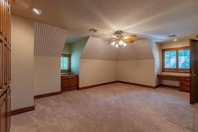 bonus room with ceiling fan, light colored carpet, and vaulted ceiling