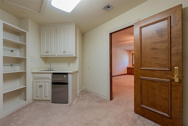 12308 Bywater Rd, Oklahoma City, OK 73170 - bar featuring freestanding refrigerator, light colored carpet, and built in shelves