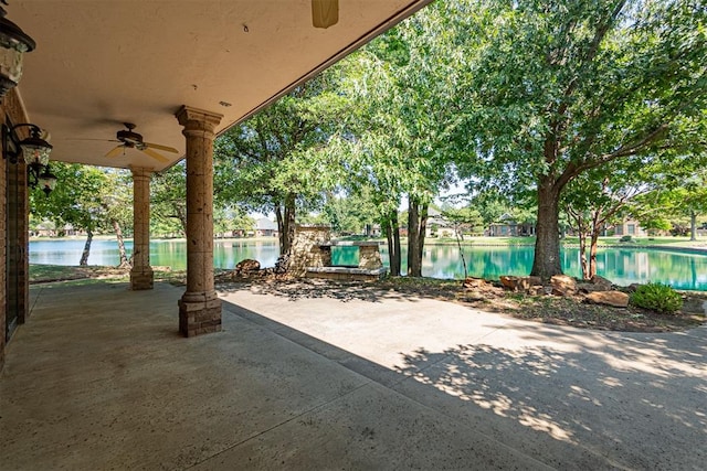 view of patio / terrace with ceiling fan and a water view