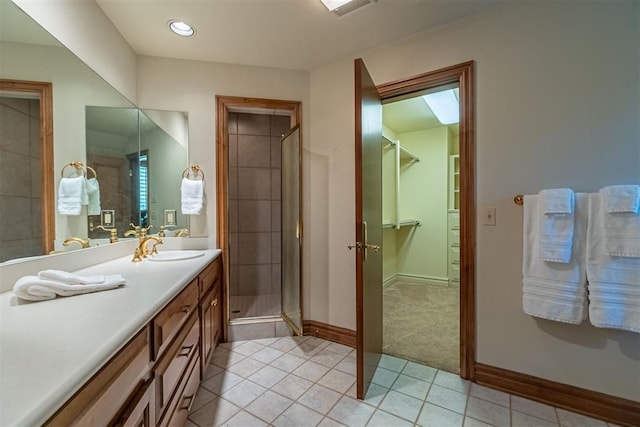 12308 Bywater Rd, Oklahoma City, OK 73170 - full bath featuring tile patterned floors, vanity, a spacious closet, and a stall shower
