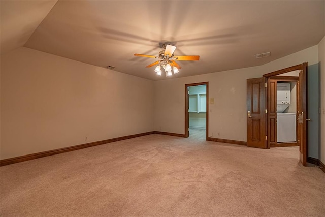 12308 Bywater Rd, Oklahoma City, OK 73170 - unfurnished room featuring stacked washing machine and dryer, light colored carpet, and a ceiling fan