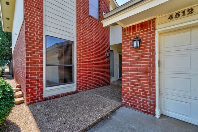 view of exterior entry with a garage