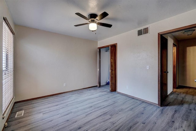 unfurnished bedroom featuring light hardwood / wood-style floors and ceiling fan