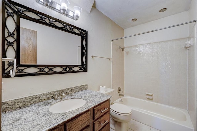 full bathroom featuring tile patterned flooring, toilet, vanity, and tiled shower / bath