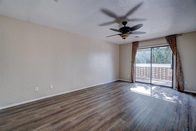 unfurnished room featuring ceiling fan and dark wood-type flooring