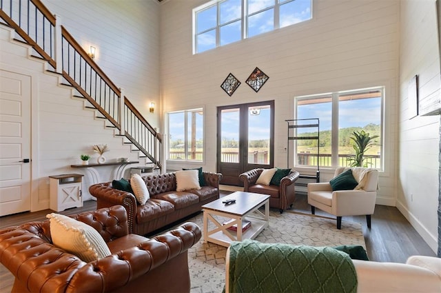 living room featuring a towering ceiling and hardwood / wood-style flooring