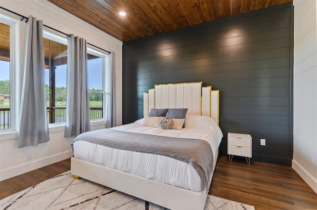 bedroom featuring hardwood / wood-style flooring, wood walls, and wood ceiling